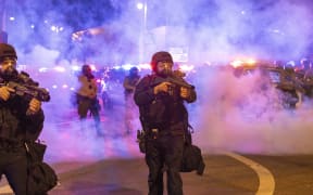 Law enforcement take positions on the streets surrounding the federal building during a protest following federal immigration operations in Los Angeles, California, on June 8, 2025. Demonstrators torched cars and scuffled with security forces in Los Angeles on June 8, as police kept protestors away from the National Guard troops President Donald Trump sent to the streets of the second biggest US city. (Photo by RINGO CHIU / AFP)