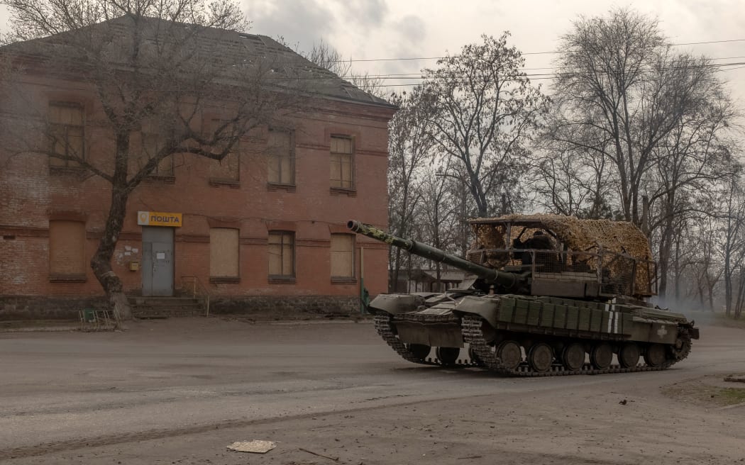 A Ukrainian tank drives on a road in a village in the Dnipropetrovsk region, on March 16, 2025, amid the Russian invasion of Ukraine. (Photo by Roman PILIPEY / AFP)